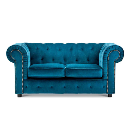 Teal velvet chesterfield sofa with button tufting and nailhead trim.