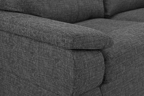 Close-up of gray fabric corner sofa armrest and cushions.