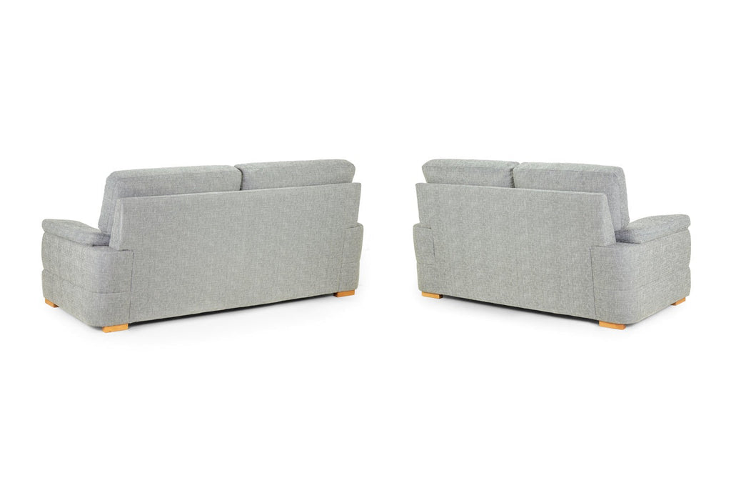 Two grey fabric sofas with wooden legs shown from the back.