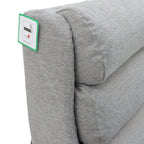 Grey fabric armchair with a fire-resistant tag.