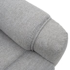 Grey fabric armchair with a rolled armrest detail.