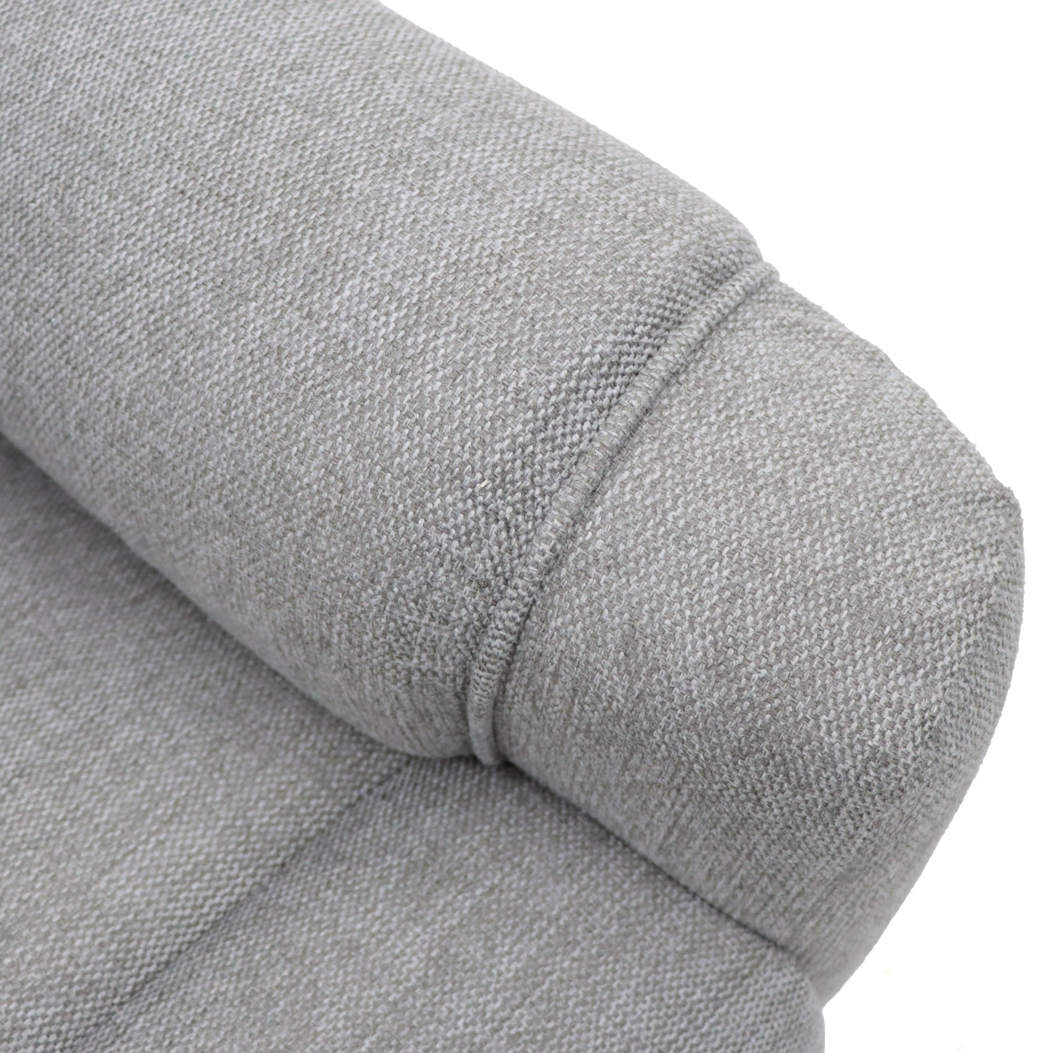 Grey fabric armchair with a rolled armrest detail.