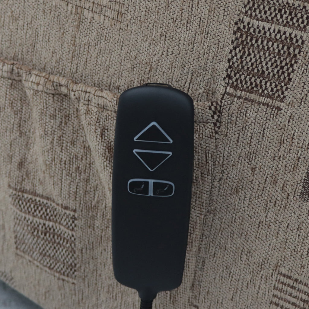 A black remote with up, down, and seat adjustment buttons rests on a tan patterned armchair.