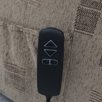 A black remote with up, down, and seat adjustment buttons rests on a tan patterned armchair.