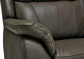 Close-up of a brown leather armchair armrest with white stitching.