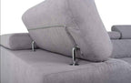 A grey fabric corner sofa bed with adjustable headrests and chrome supports.