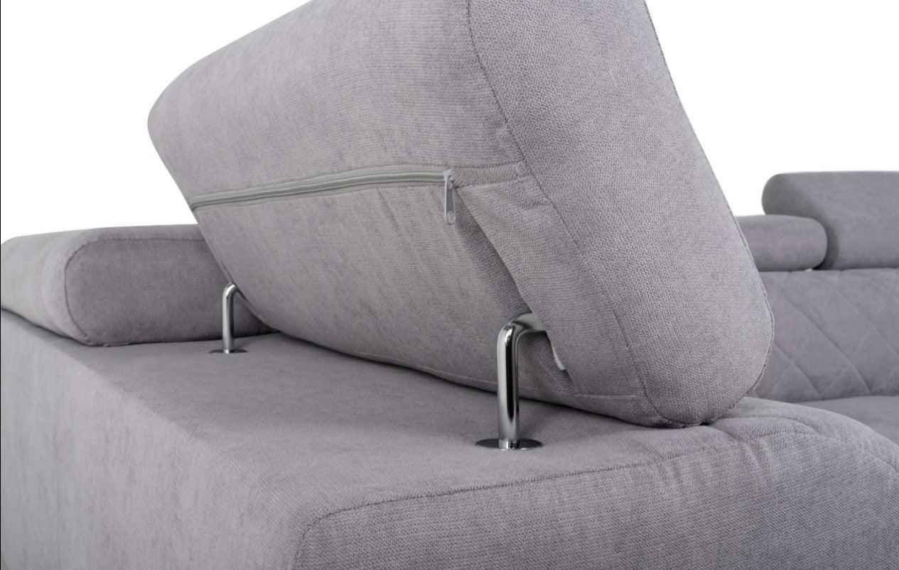 A grey fabric corner sofa bed with adjustable headrests and chrome supports.