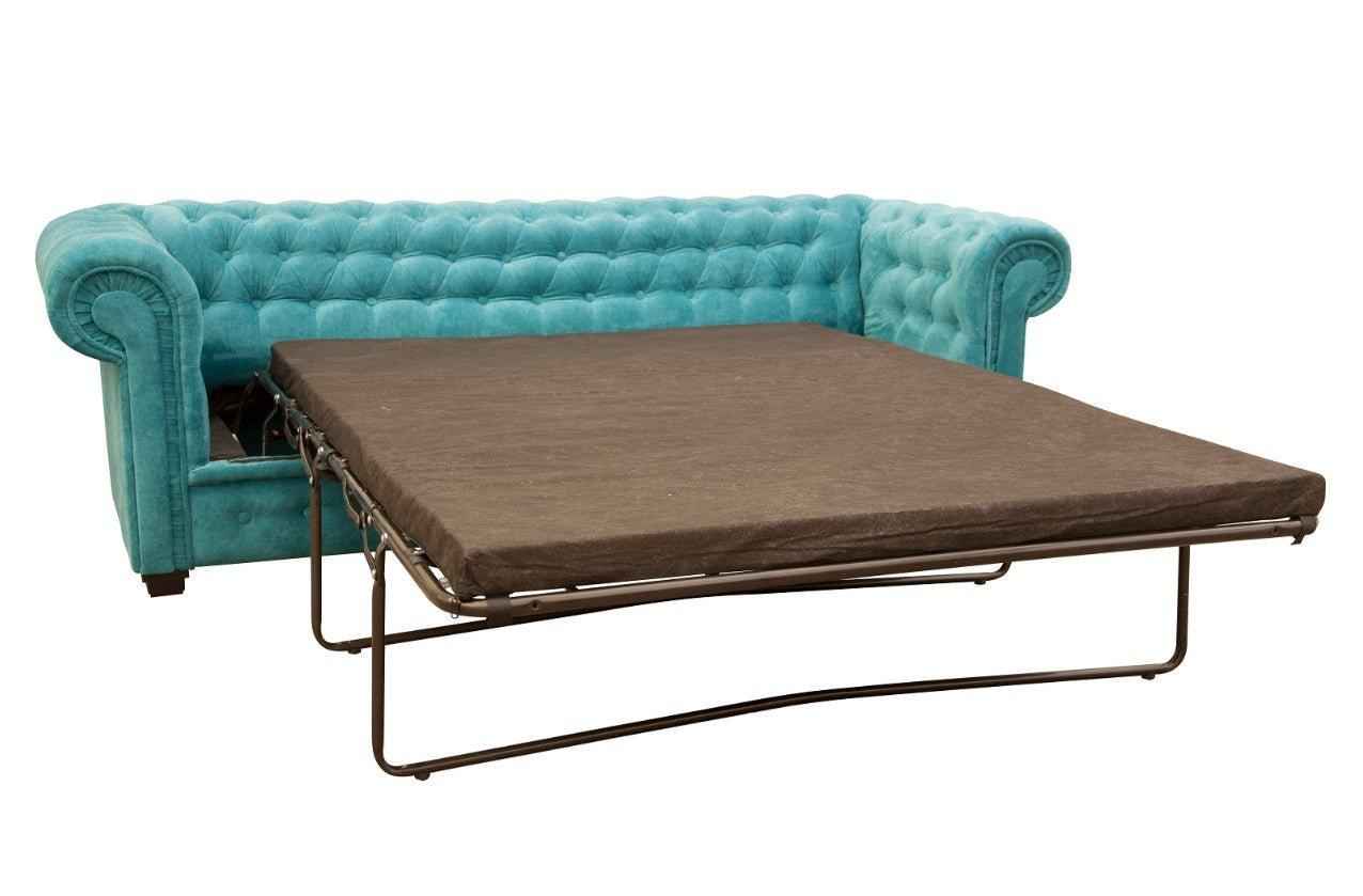 Teal fabric Chesterfield sofa bed with a pull-out mattress.
