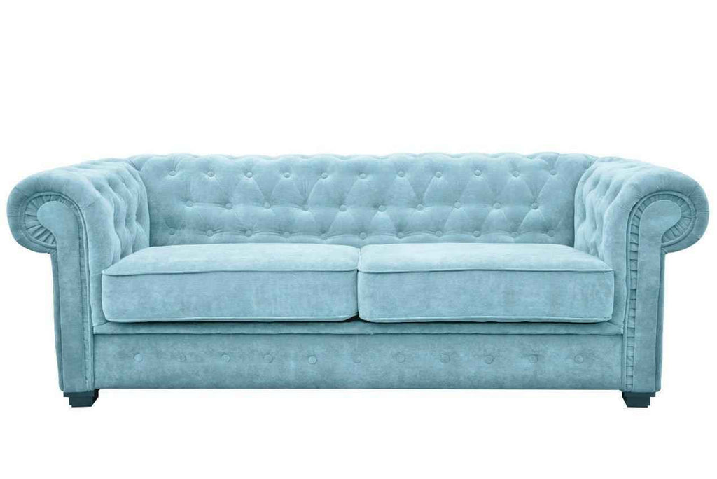 A light blue fabric Chesterfield sofa bed with tufted back and rolled arms.