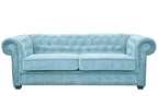 A light blue fabric Chesterfield sofa bed with tufted back and rolled arms.
