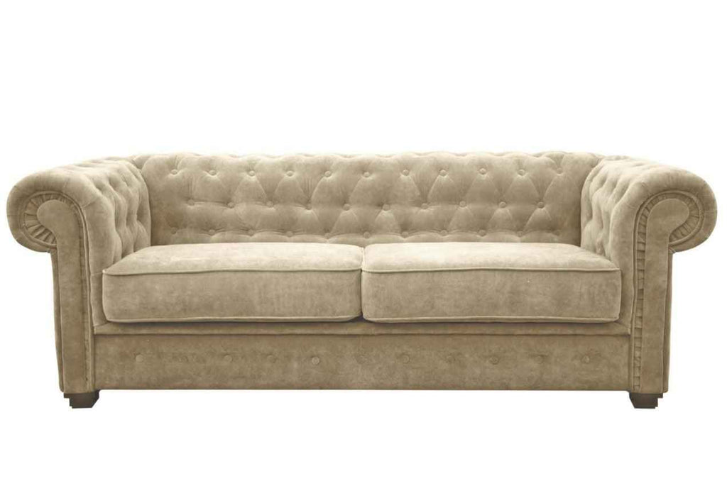 A beige fabric Chesterfield sofa bed with tufted back and rolled arms.