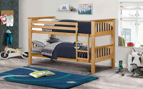 A wooden bunk bed with bedding and a ladder.