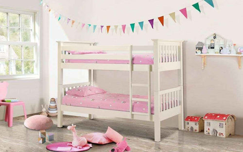 A white wooden bunk bed with pink bedding in a child's bedroom.