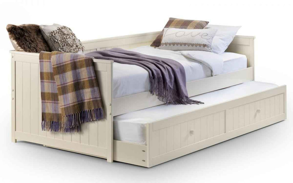Jessica daybed and underbed in stone white with plaid blanket and pillows.