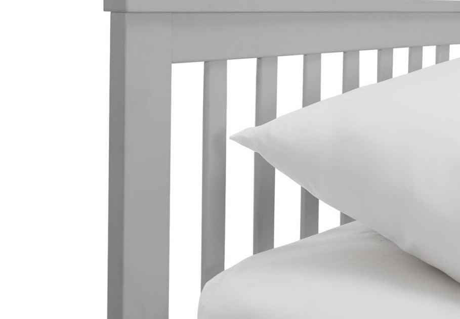A grey wooden bed frame with a slatted headboard and white bedding.