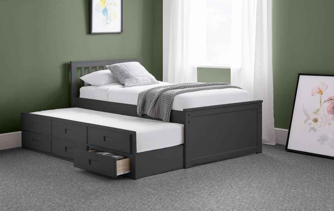 Dark grey wooden captain's bed with a pull-out trundle and six storage drawers.