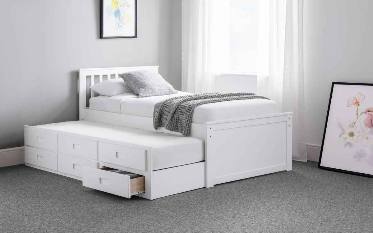 White wooden captain's bed with pull-out underbed and storage drawers.