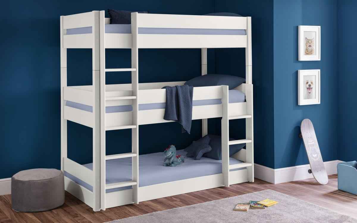 A white wooden triple bunk bed with blue bedding and a ladder.