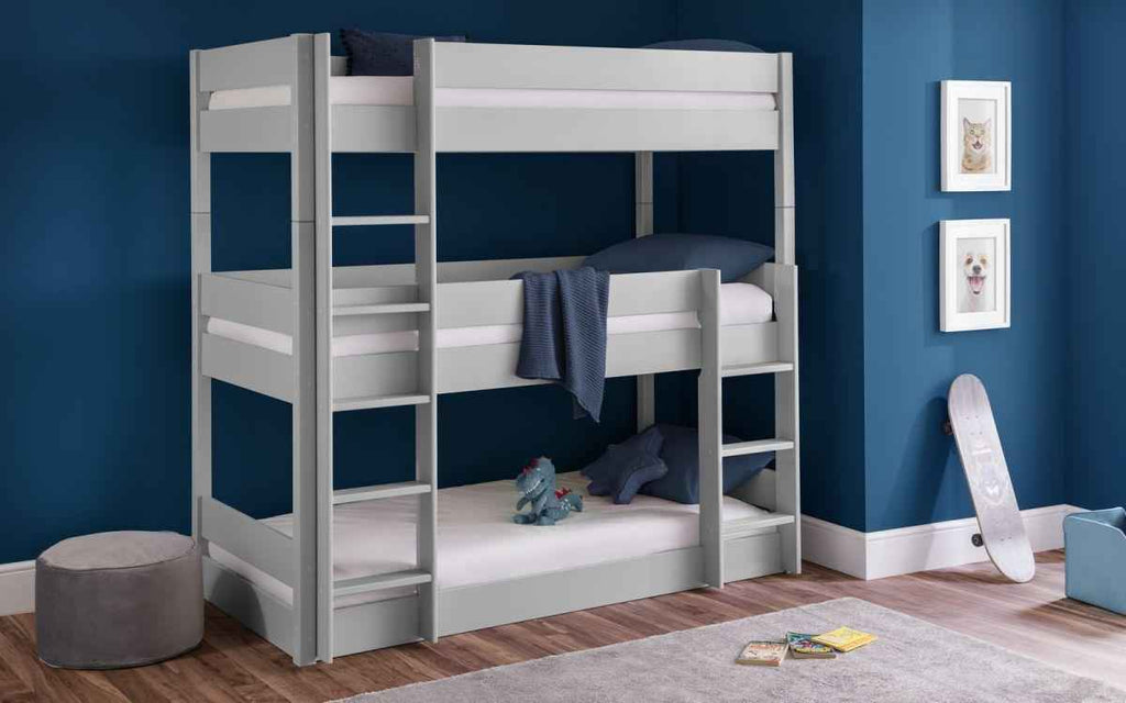 A grey wooden triple bunk bed with white mattresses and blue bedding.