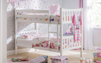 A white wooden bunk bed with floral bedding and a pink unicorn toy.